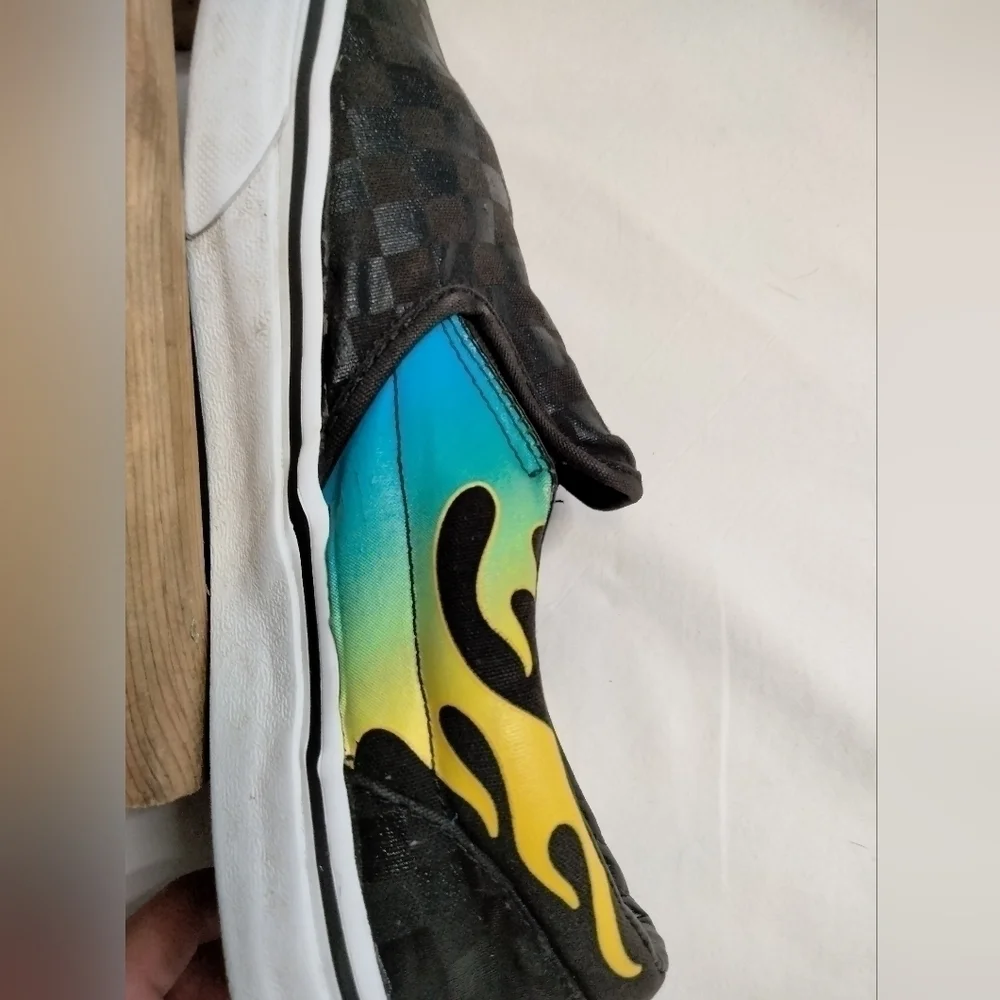 Vans slip on shoe. Size 7. Black  with blue/green and yellow🔥 running down side